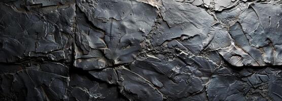 Close Up Of A Cracked And Rough Dark Grey Rock Surface photo