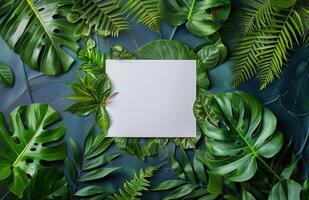 White Paper Surrounded by Lush Tropical Foliage in a Flat Lay Composition photo