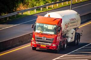 a tank trailer truck carrying Pertamina's LPG or liquid petroleum gas passing fast on the toll road, Indonesia, 16 July 2024. photo