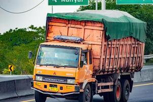 a mining dump truck carrying sand passing on the toll road, Indonesia, 16 July 2024. photo