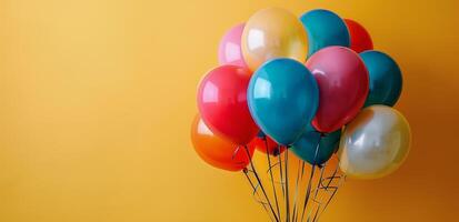 Colorful Balloons Against A Yellow Background photo