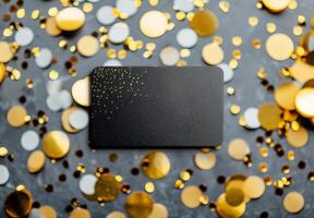 Black Card With Gold Glitter on Gray Background photo