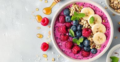 Pink Smoothie Bowl With Berries and Banana photo