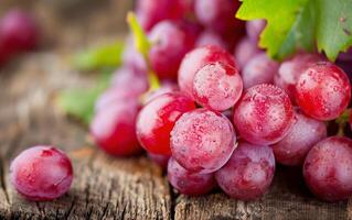 Red Grapes With Dew on Wooden Surface photo