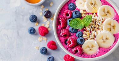 Pink Smoothie Bowl With Berries and Banana photo