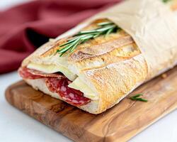 Salami and Cheese Baguette on Cutting Board photo
