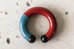 Red And Blue Wooden Ring On White Surface photo
