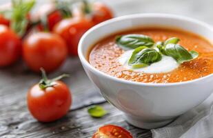Tomato Basil Soup With Cream and Basil Garnish photo