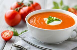Tomato Basil Soup With Cream and Basil Garnish photo