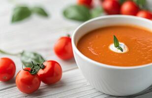 Tomato Basil Soup With Cream and Basil Garnish photo