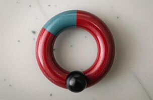 Red And Blue Wooden Ring On White Surface photo