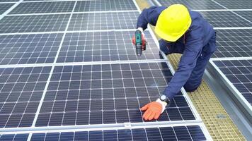 A Technician using drill installing solar cells. photo