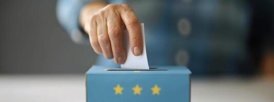 Person Voting in Ballot Box photo