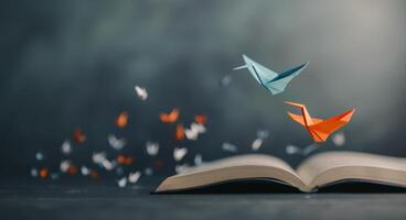 Origami Cranes Flying Over Open Book photo
