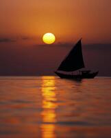 Sailboat Silhouette at Sunset photo