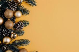 Christmas Ornaments and Pine Branches on Yellow Background photo