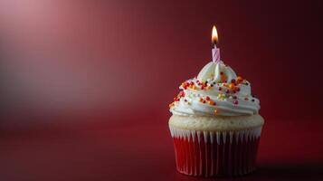 Birthday Cupcake With Candle on Red Background photo