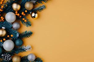 Christmas Ornaments and Pine Branches on Yellow Background photo