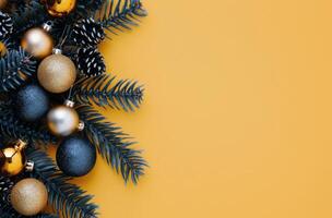Christmas Ornaments and Pine Branches on Yellow Background photo