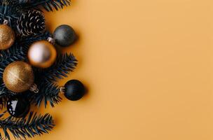 Christmas Ornaments and Pine Branches on Yellow Background photo