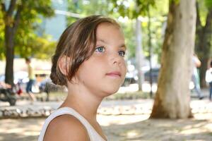 Cute kid girl 10 year old posing on nature background. Looking at camera photo