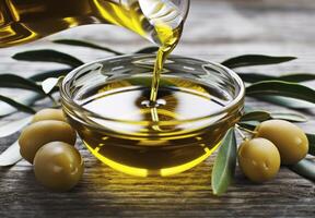Olive Oil Pouring Into Bowl With Olives photo