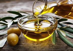Olive Oil Pouring Into Bowl With Olives photo