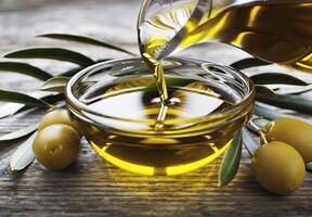 Olive Oil Pouring Into Bowl With Olives photo