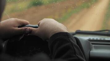 man hands on the steering wheel of an suv video
