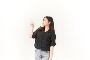 Young Asian woman presenting and pointing side copyspace wearing Black t-shirt and jeans isolated on white background photo