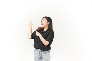 Young Asian woman presenting and pointing side copyspace wearing Black t-shirt and jeans isolated on white background photo