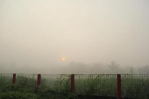 a foggy day with a fence and a fence photo