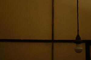 a person standing in front of a yellow wall with a sticker on it photo