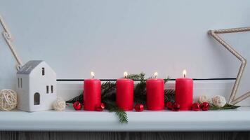 Four Advent red candles burning , fir branches and Christmas zero waste decorations in windowsill. Holiday preparation. Catholic traditions of Christmas new year winter holidays candlelight countdown video