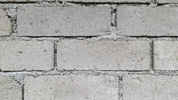 A close up of a concrete block wall The textured surface has a rough uneven look photo
