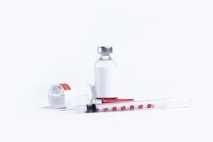 Medical vials and syringe isolated on white background. photo
