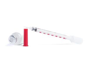 Medical syringe and vaccine vial isolated on a white background. Closeup photo