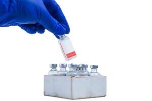 Blue glove holding a vial for collecting blood samples isolated on white background. closeup photo