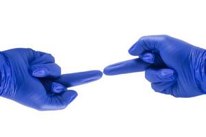 Two blue gloved hands pointing to each other with middle finger on white background. copy space photo