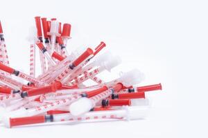 Red plastic syringes isolated on white background with copy space. photo