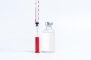 Vaccine bottle and syringe isolated on white background with copy space. photo