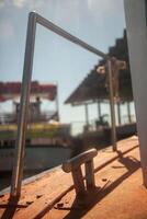 Close-up of a boat cleat on a ferry crossing between Tavira and Tavira Island in Algarve, Portugal. With the sea and distant coastline in the background. photo