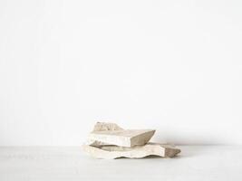 Grey natural stones podium on white background, platform for product display. photo
