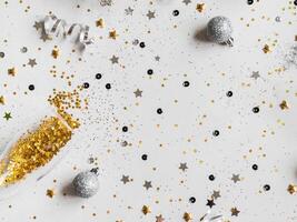 Flat lay of Christmas or New Year, gold and silver party season decorations on white background. photo