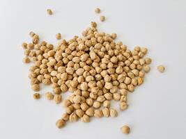 Raw dry chickpea on white background. Traditional ingredient for cooking hummus. Middle Eastern and Mediterranean cuisine. Selected focused photo