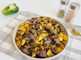 Sapi lada hitam, Indonesian and Chinese cuisine. Black Pepper Beef, is a fast, easy stir-fry made with beef, onions, and peppers seasoned with oyster sauce and loads of black pepper. photo