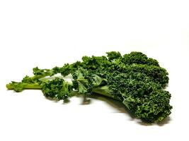 Kale leaf salad vegetable isolated on white background. Creative layout made of kale closeup. Food concept. photo