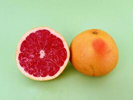Fresh grapefruit fruit. Grapefruit isolated on green background. Grapefruit with clipping path. photo