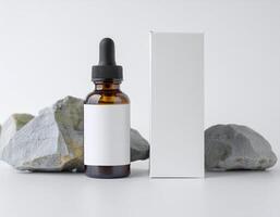 a bottle of essential oil next to some rocks photo