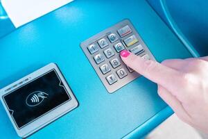 A womans finger is pressing a button on a communication device photo